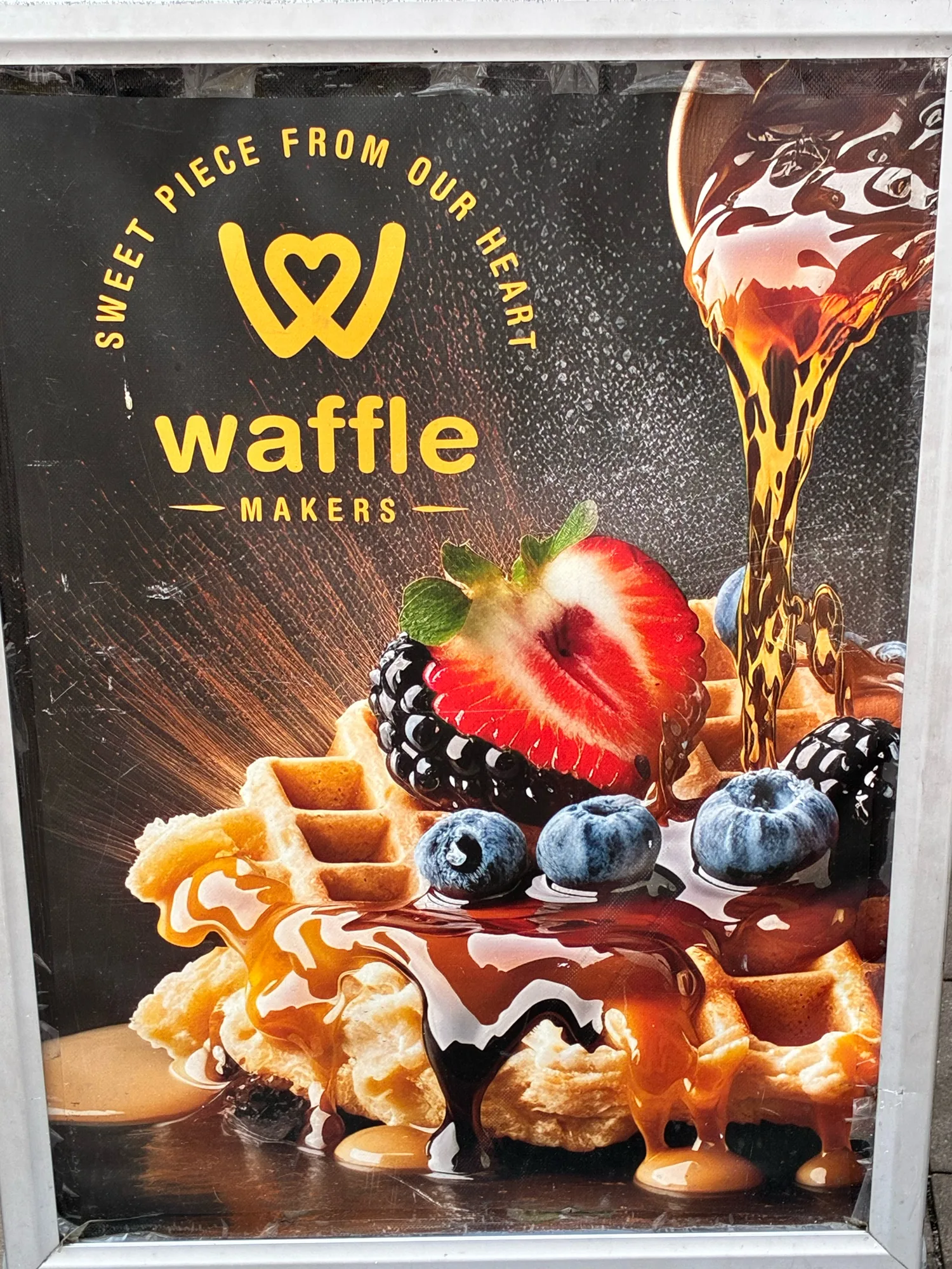 A Waffle Makers advertisement showing an AI-generated waffle and fruit