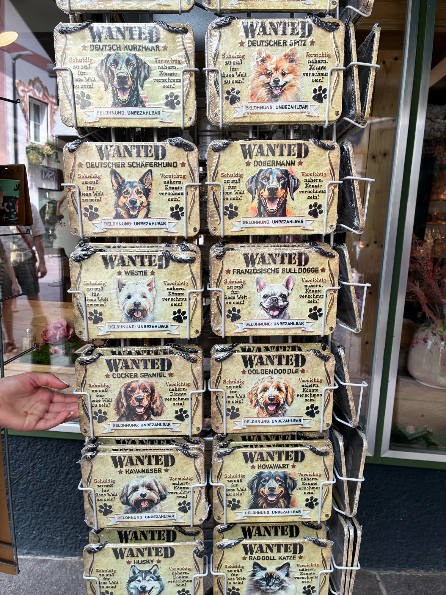 A rack of wanted-style dog souvenir posters made with AI-generated portraits